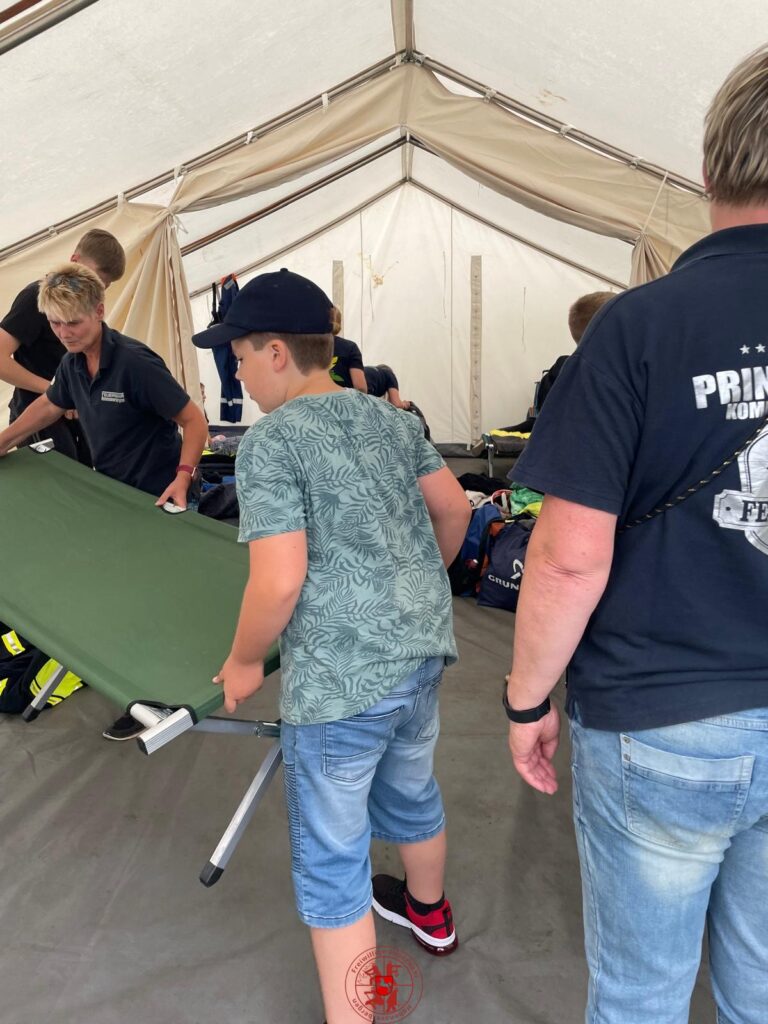 die Liegen werden in das aufgebaute Zelt getragen